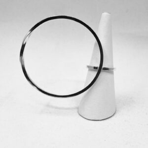 A ring holder with a silverring shaped as a big twisted circle