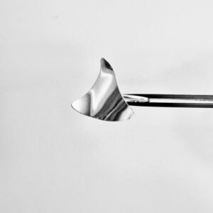 A tweezer holding a silver ring shaped as a wavy triangle.