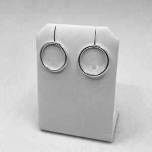 Silver earrings shaped as circles on a earring holder