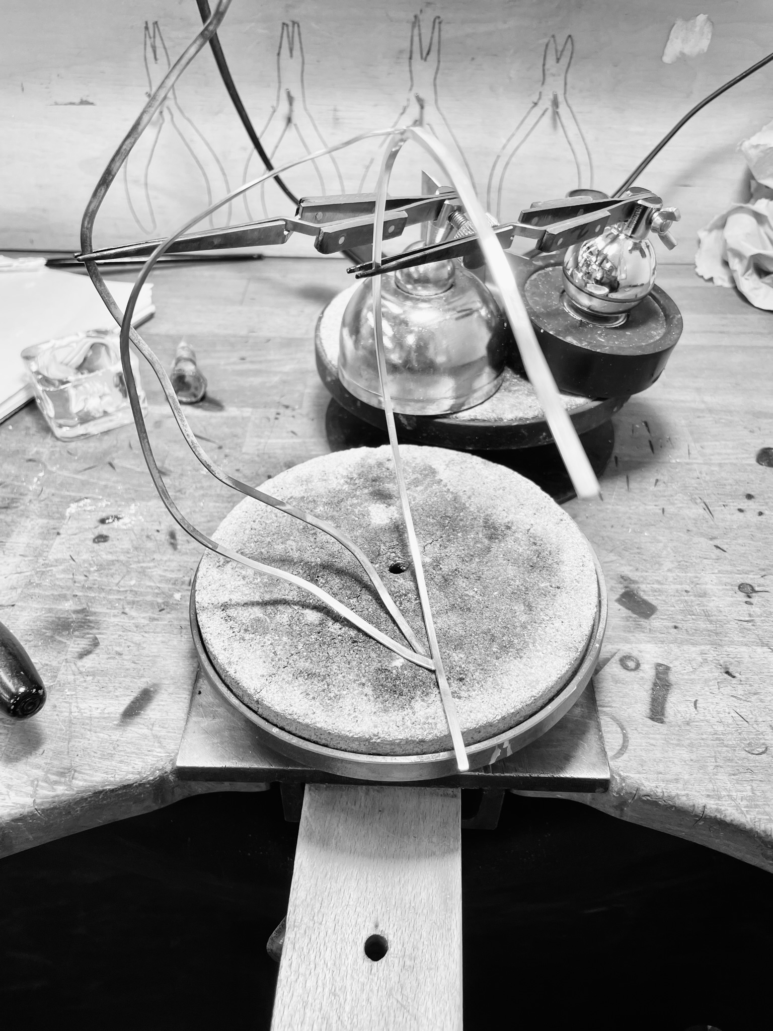A silver tiara in the making on a silversmith's bench