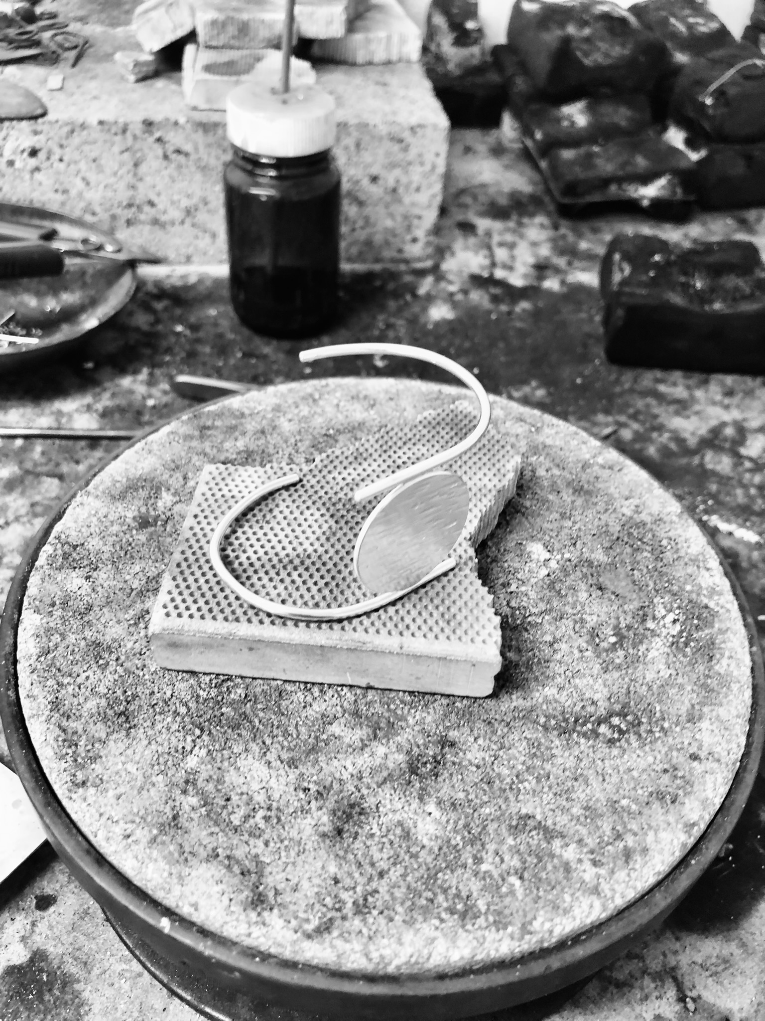 A silverbracelet in the making on a silversmith's bench
